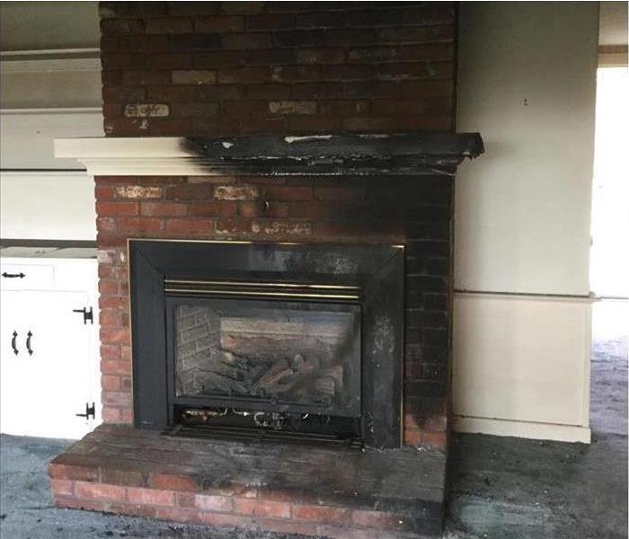 charred and burnt fireplace mantle and soot