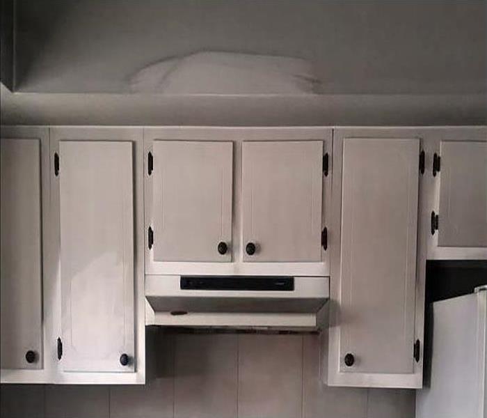smoke damaged cabinets in a kitchen after a fire
